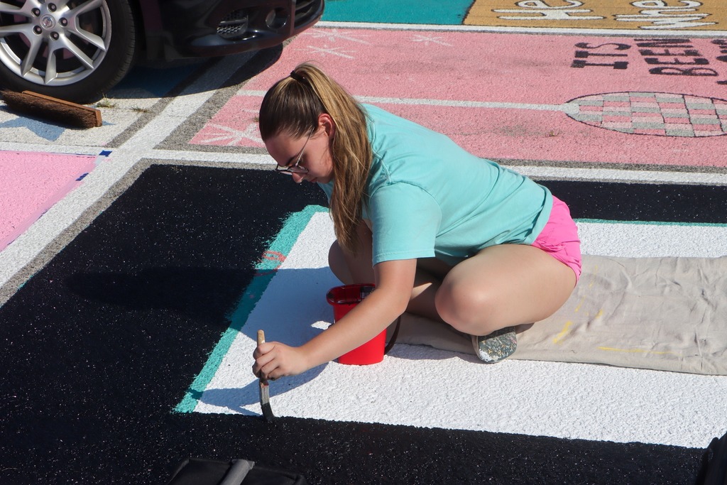 students paint senior parking spots