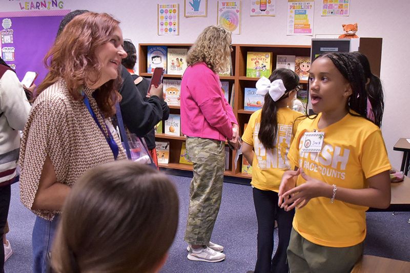 Green Leadership in Me attendee talks with student