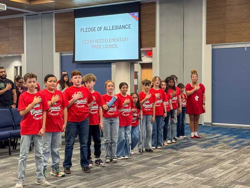 Reed Elementary students lead the Board in the Pledge of Allegiance