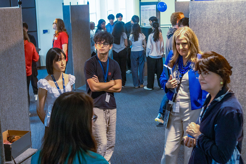 IB Students at Science Exposition with high school staff members