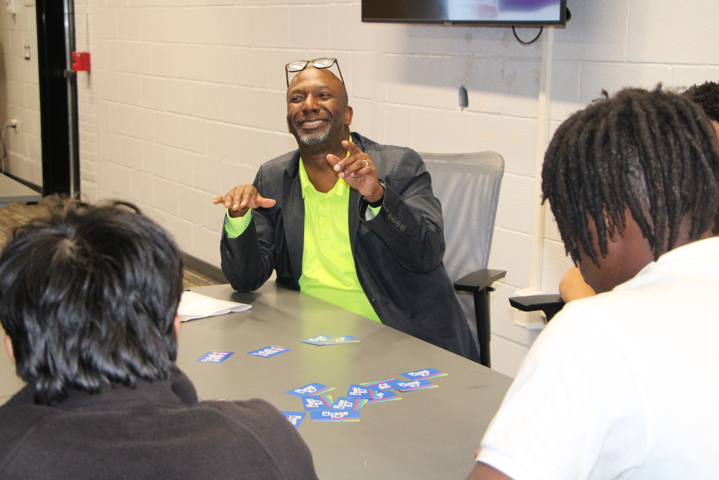 students and dr. miller playing phase 10 