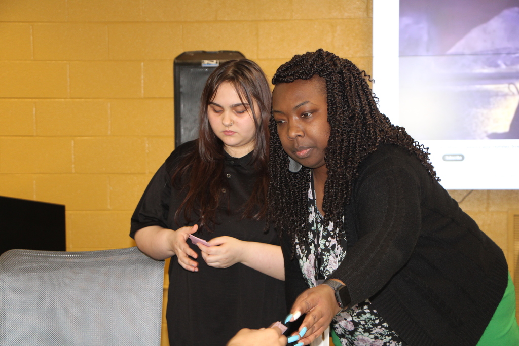 mrs patterson helping a student play monopoly