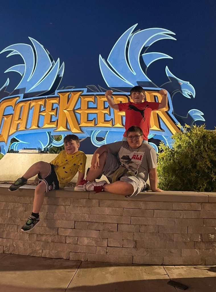 Aeson, Alex and Haiden in front of the sign for GateKeeper