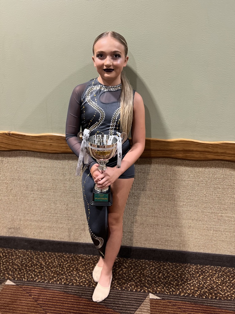 Alexandria holding a trophy