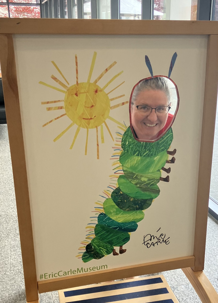 Mrs. Coler with her face in the hunger caterpillar cut out