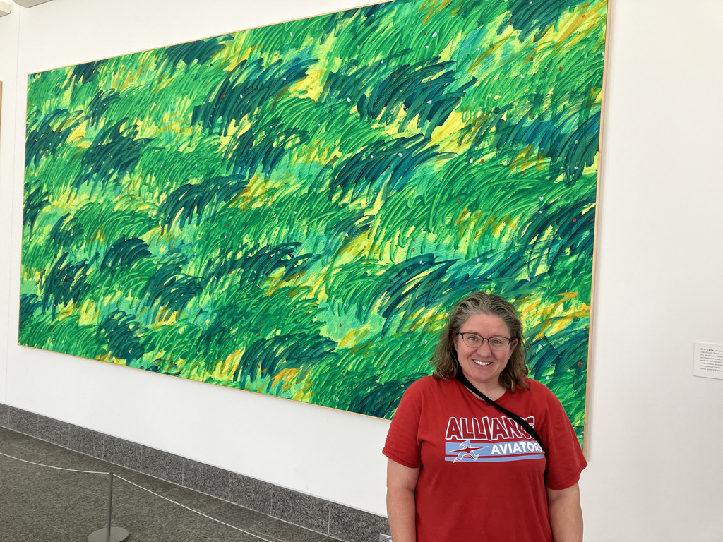 Mrs. Coler in front of a painting