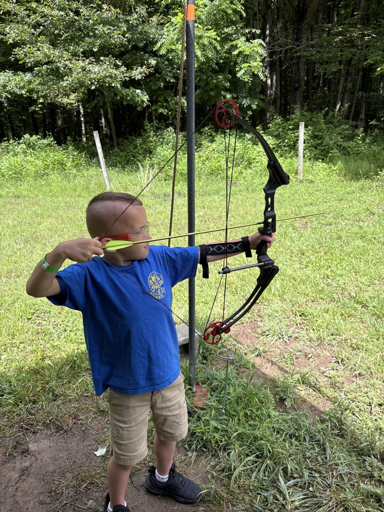 one of the students shooting a bow and arrow