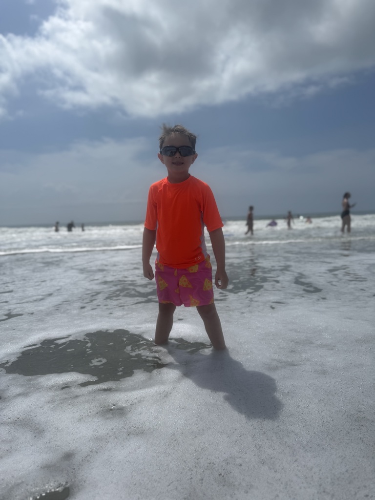 Landon wearing sun glasses in the ocean