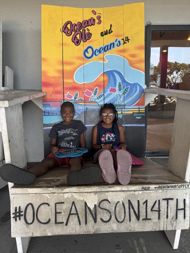 savannah and reign sitting on a giant chair