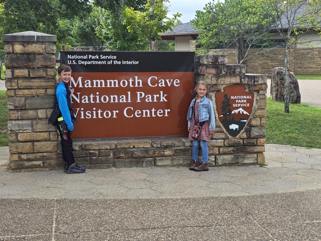Addison and her brother by the Mammoth cave sign