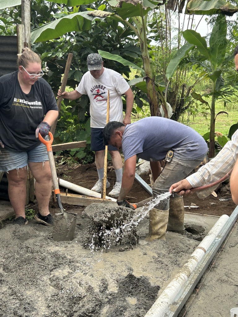 students helping with concrete