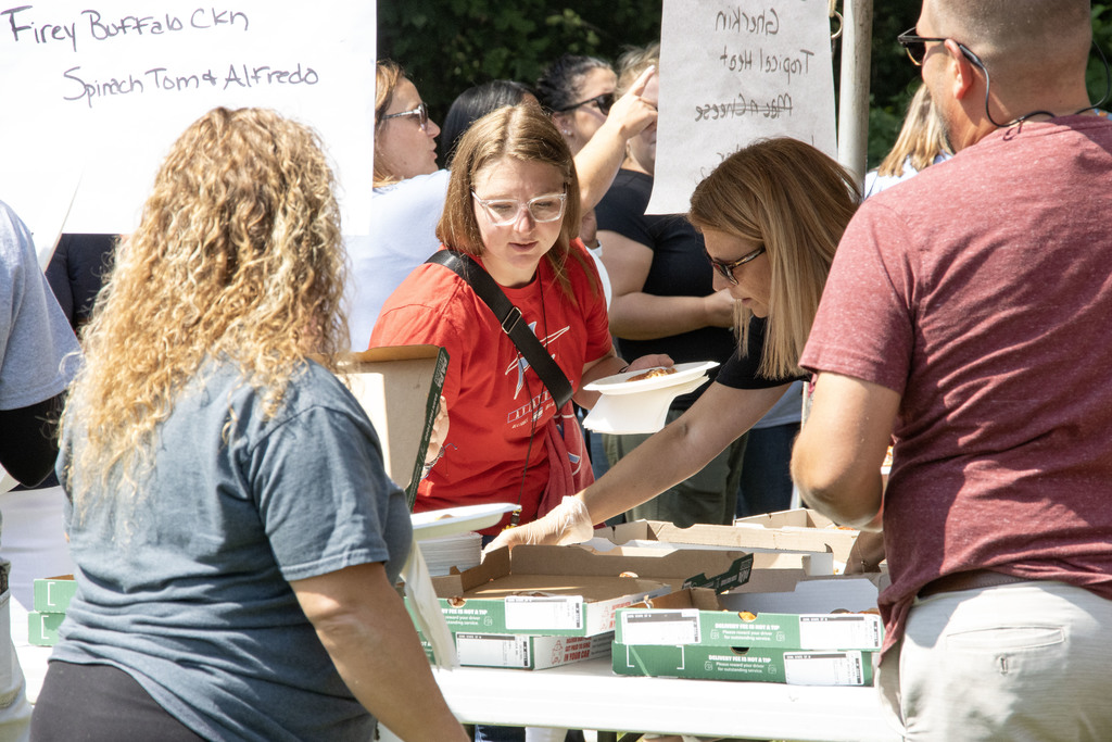 Staff members picking the pizza they want to try