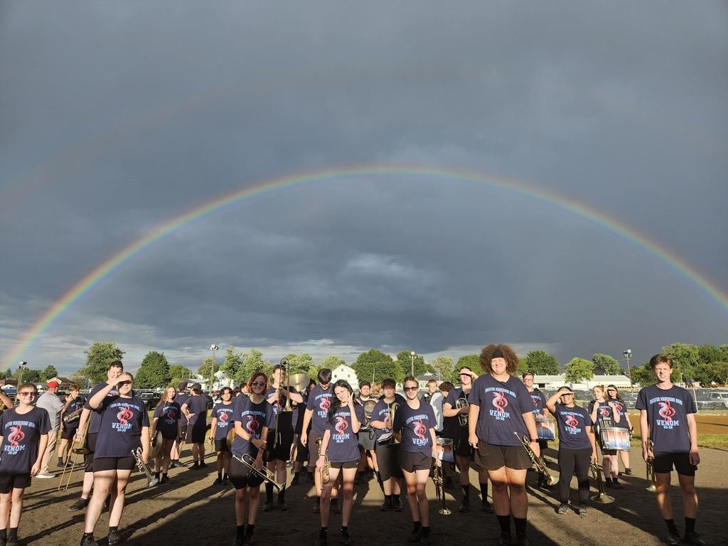 band students standing under a rainbow