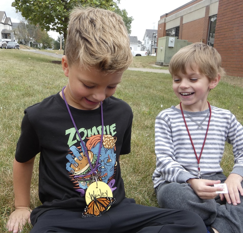 students holding butterflies