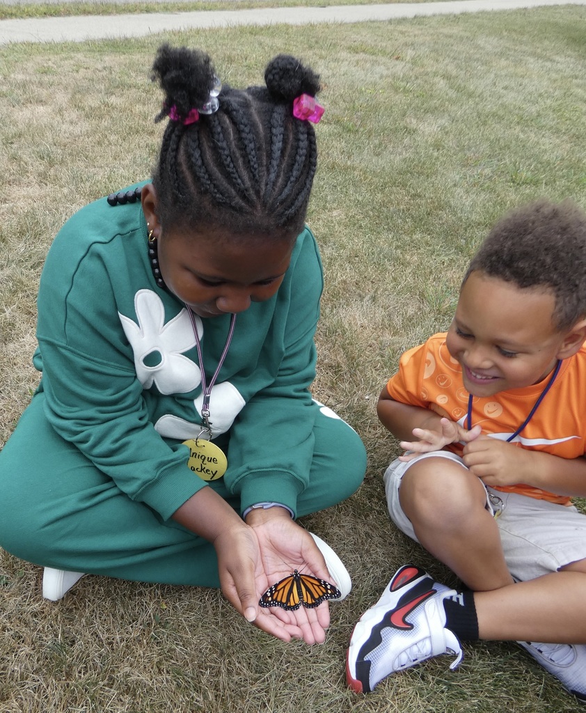 students holding butterflies