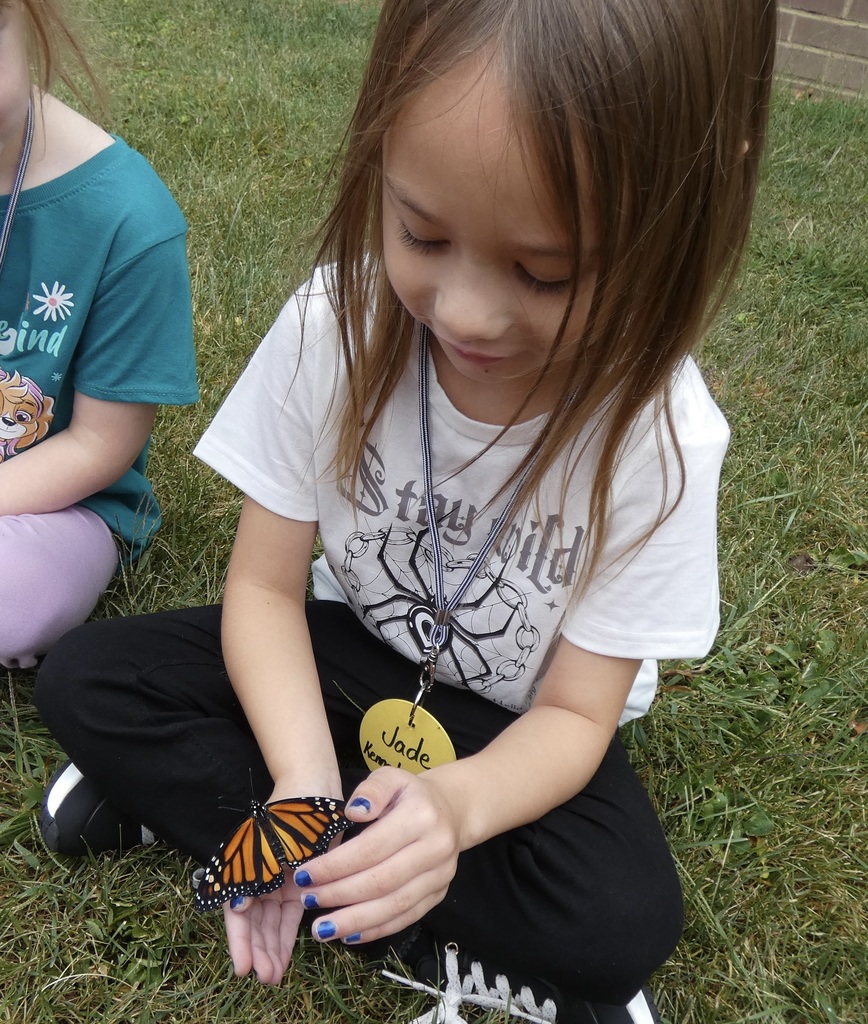 students holding butterflies