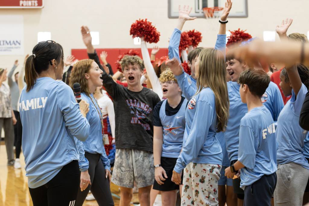 cross country team raising their hands