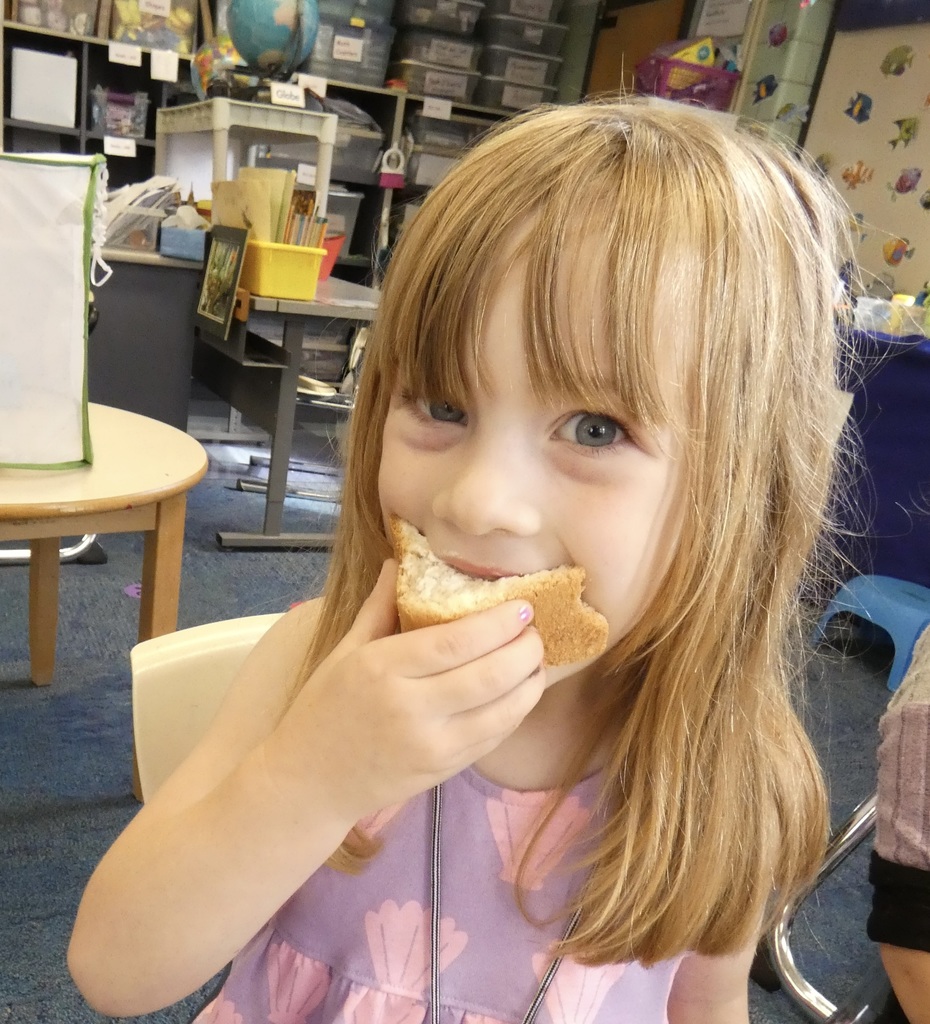 student taking a bite of bread