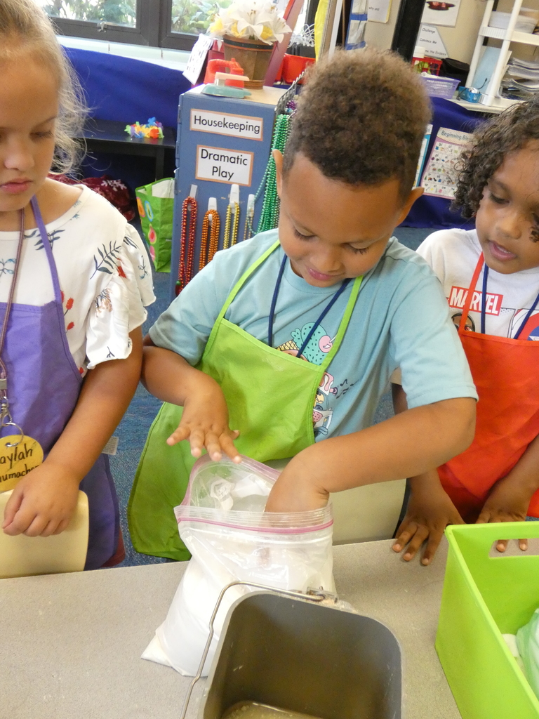 student measuring flour