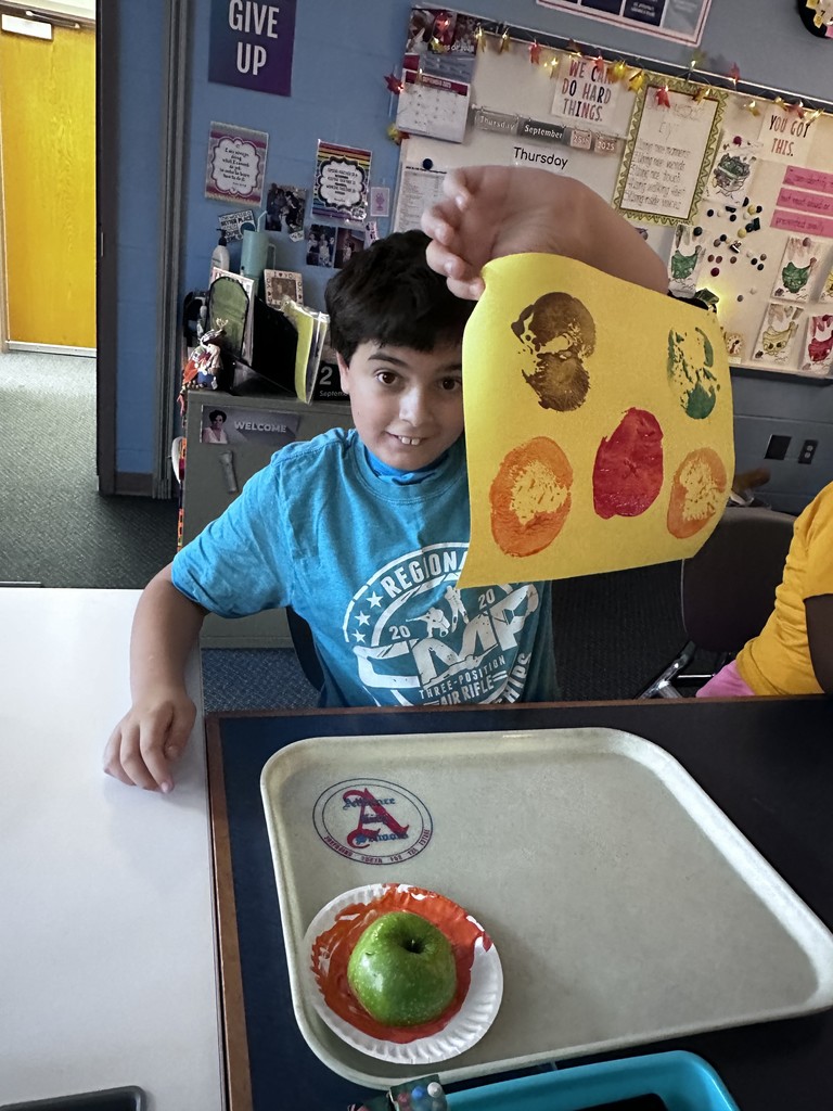 students doing crafts with apples