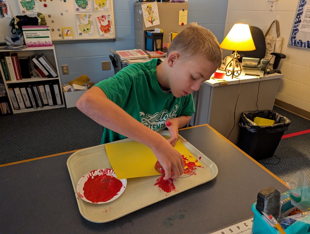 students doing crafts with apples
