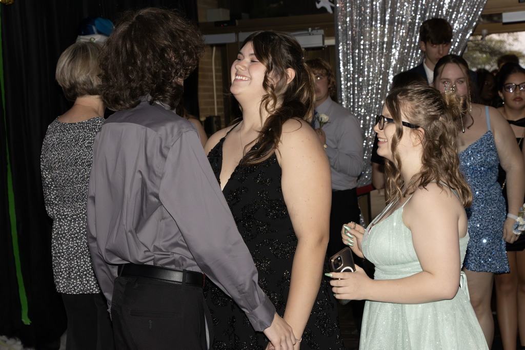 students holding hands and smiling at each other