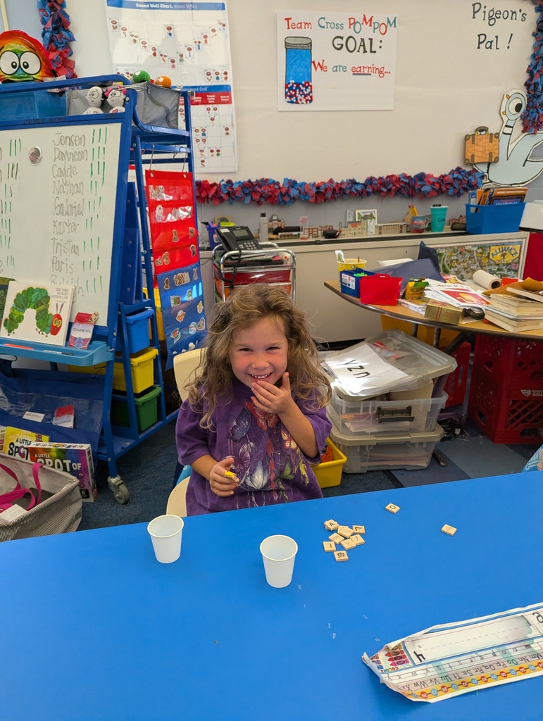 A student smiling and holding her hand over her mouth