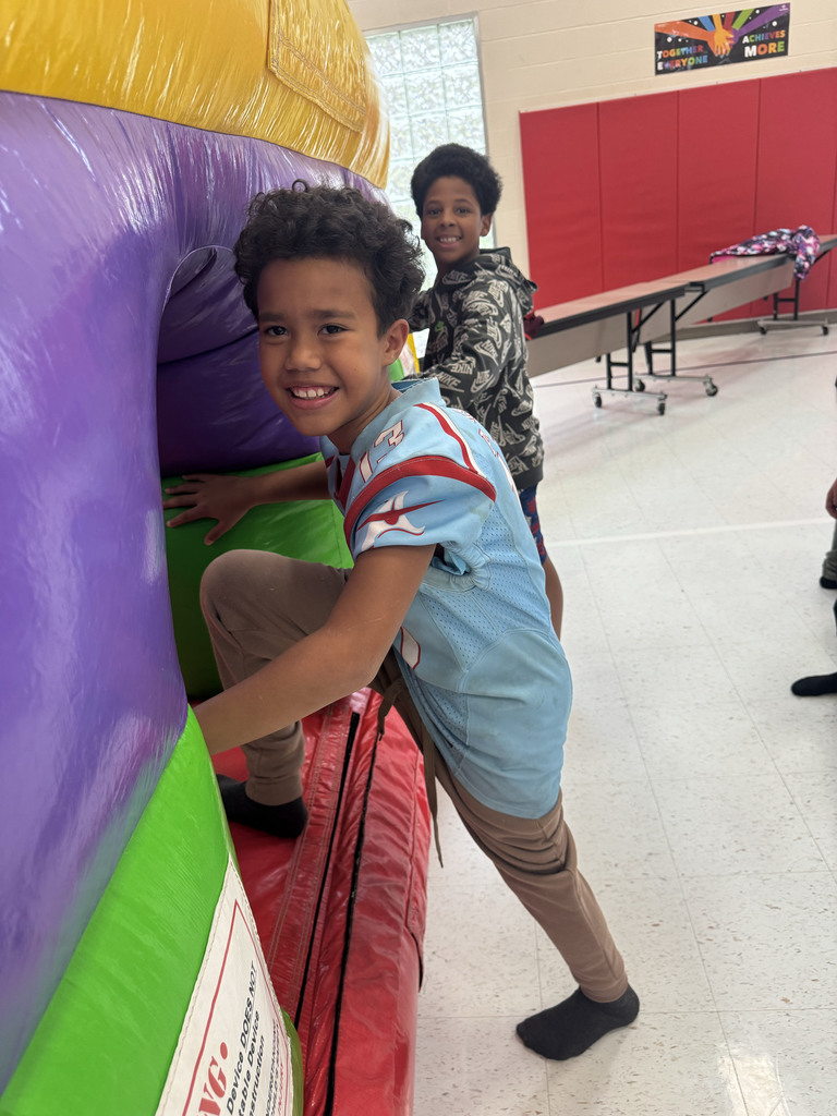 students entering a bounce house