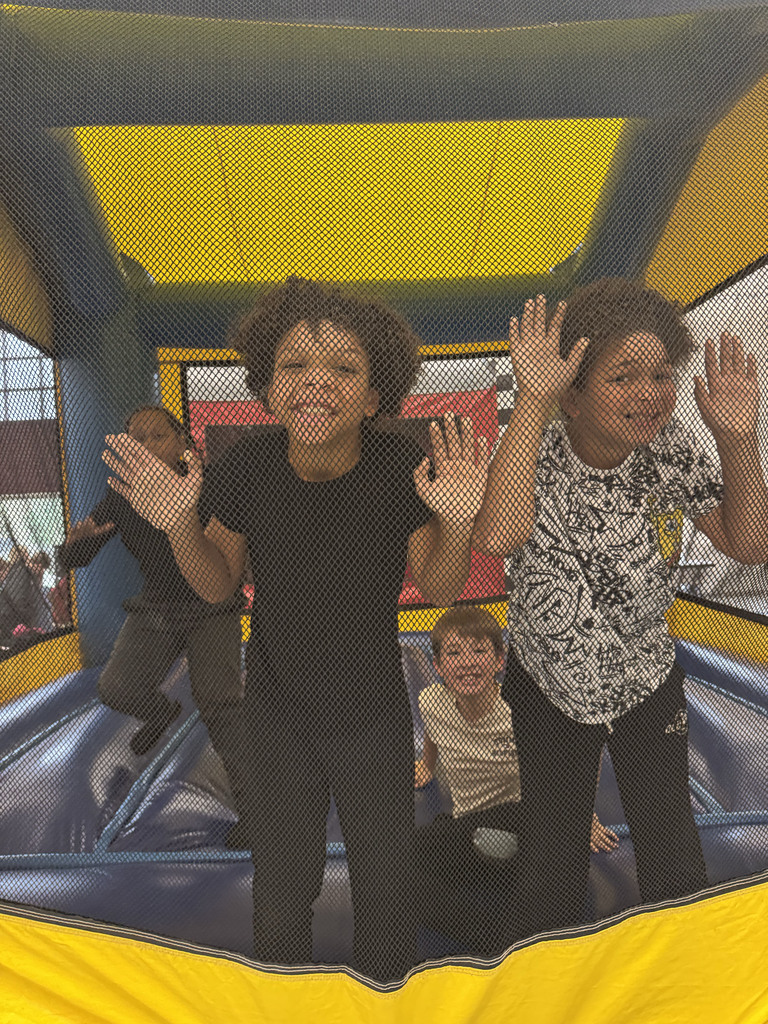 students smiling in a bounce house