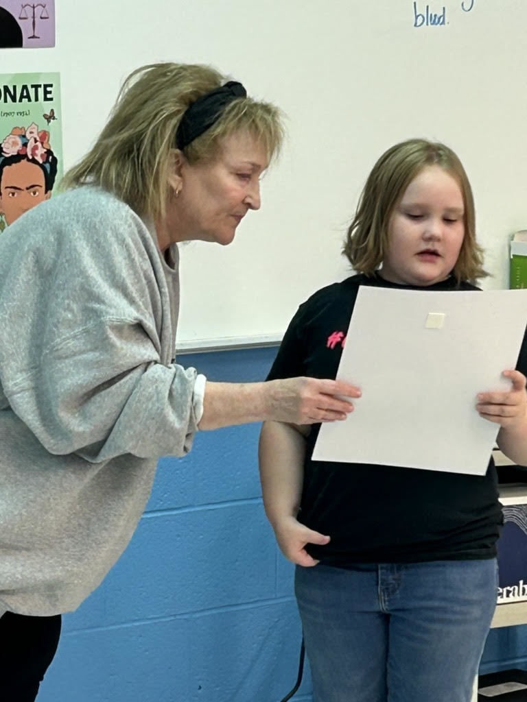 student reading a poster