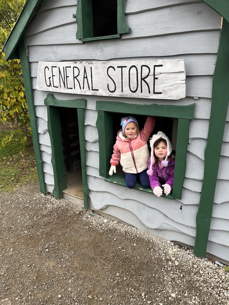 Students standing in a little play house