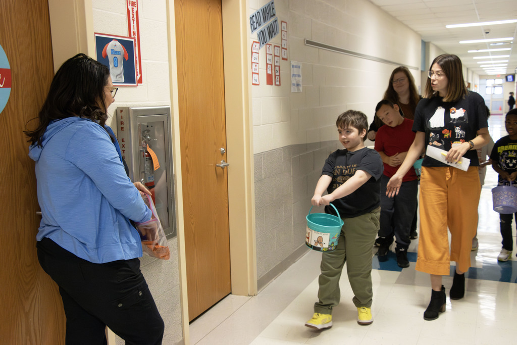 Students walk up to Jenna Allman, school psych to get their first treat