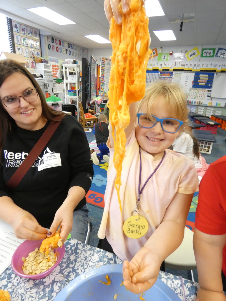 Student holding up the pumpkin guts and seeds