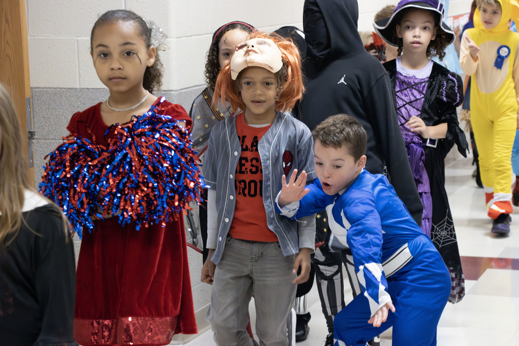Students in costume walking down the hall