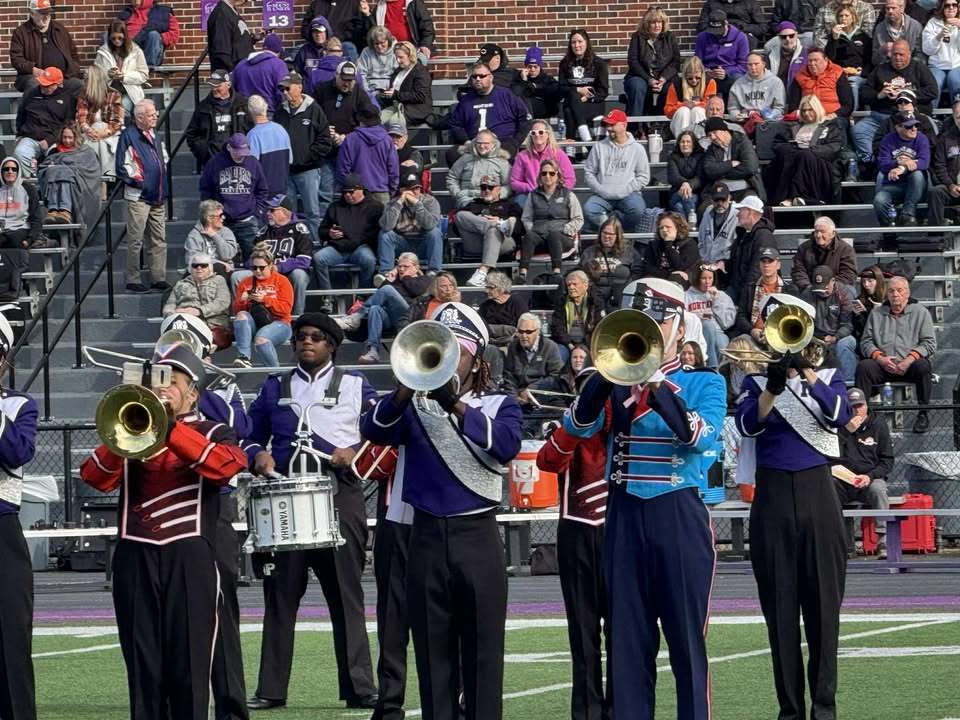 student playing the trumpet alongside UMU band members