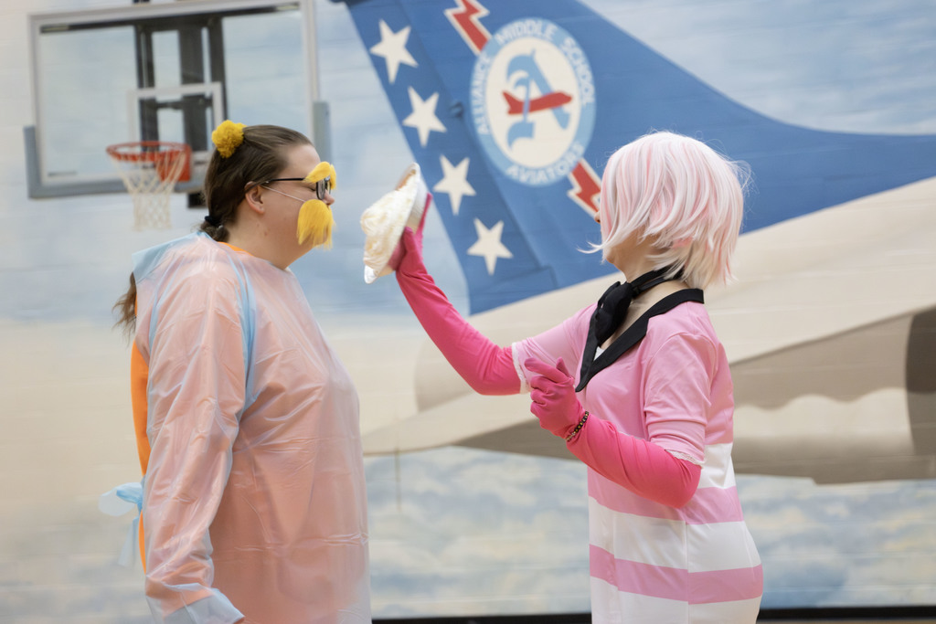 a student about to pie a teach who is dressed as the Lorax