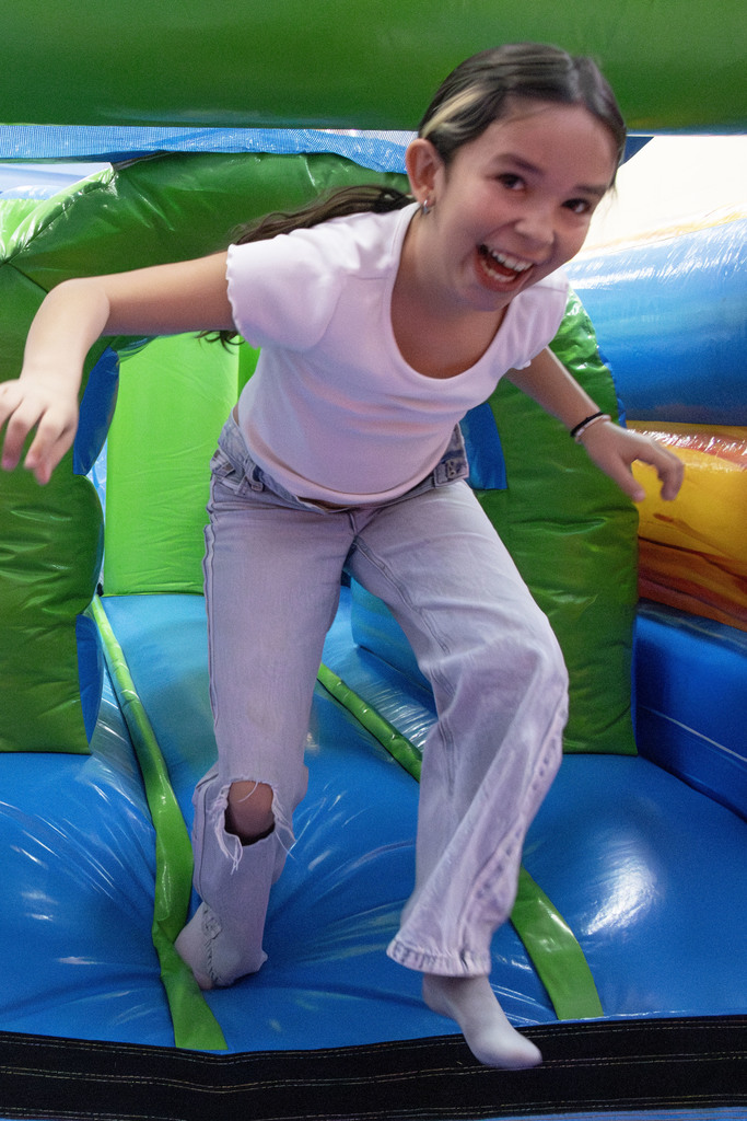 A student smiling while coming out of the obstacle course