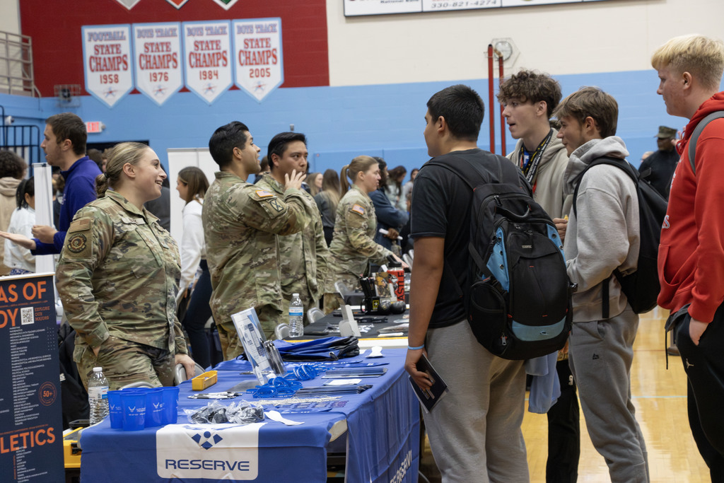 Students talking to an army reserve recruiter