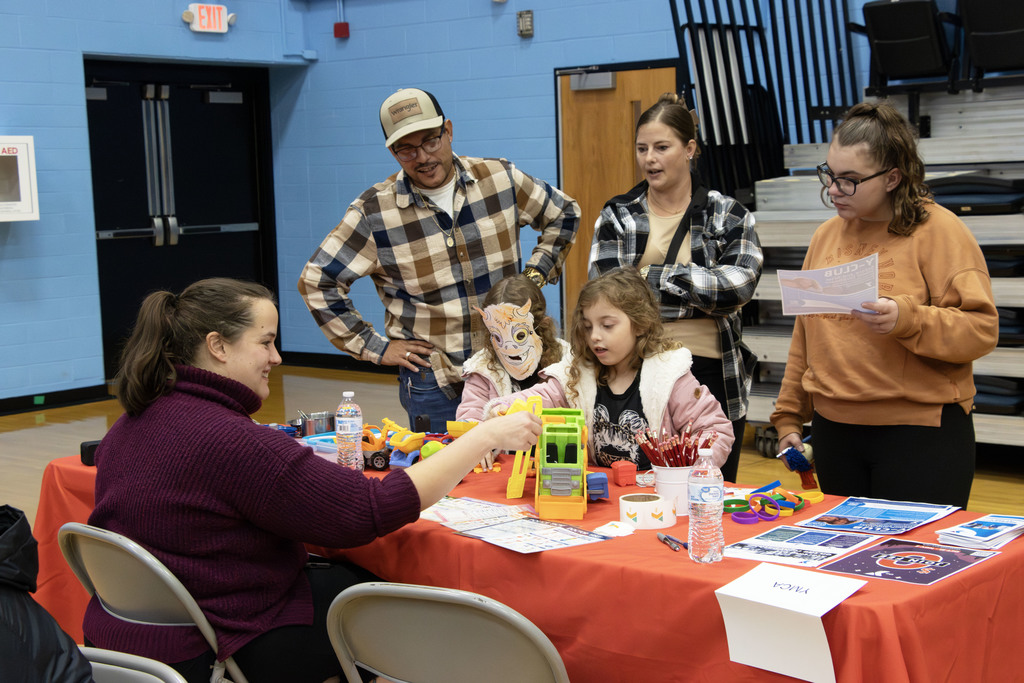 A family talking to the YMCA table