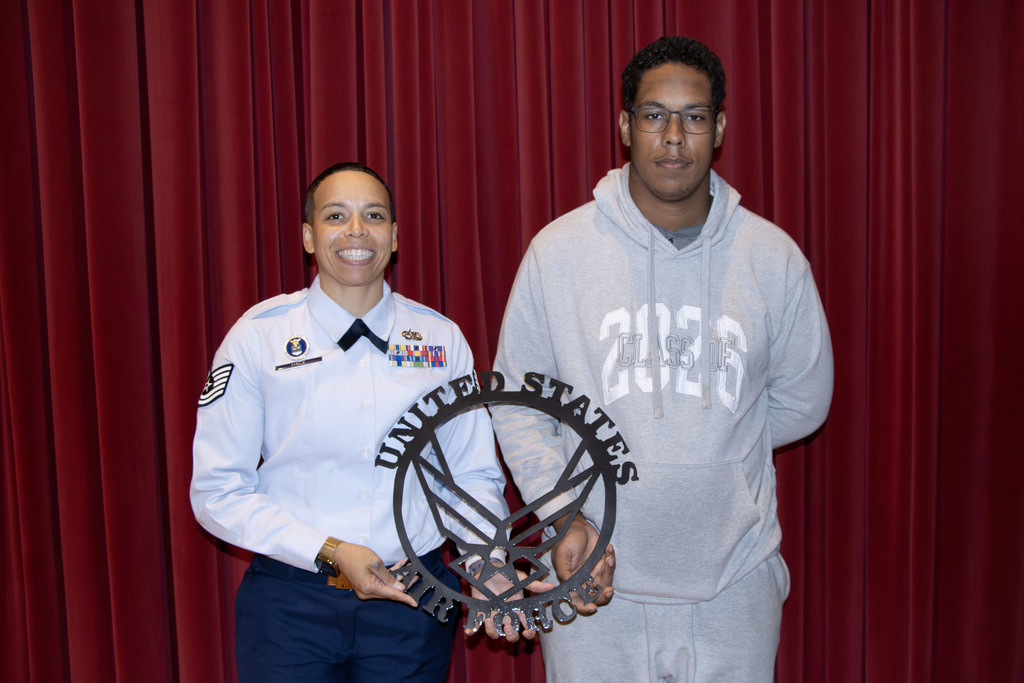 Technical Sergeant Hale standing with Senior Collin Mason