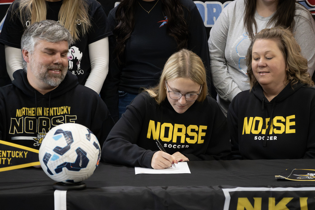 Zellie signing the document.