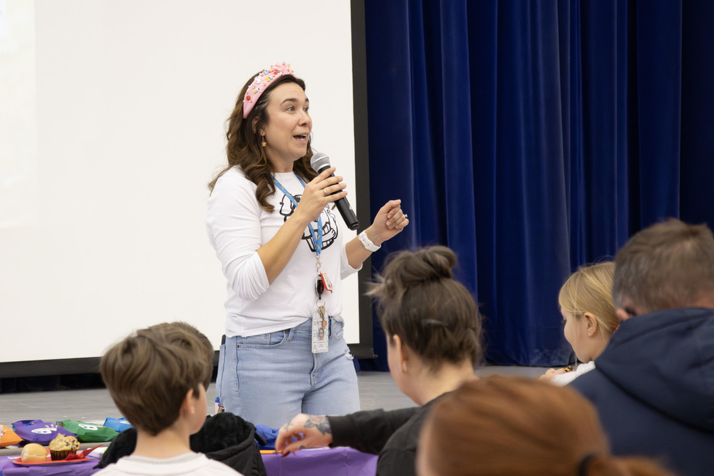 Mrs. Marinchek talking to the students and families