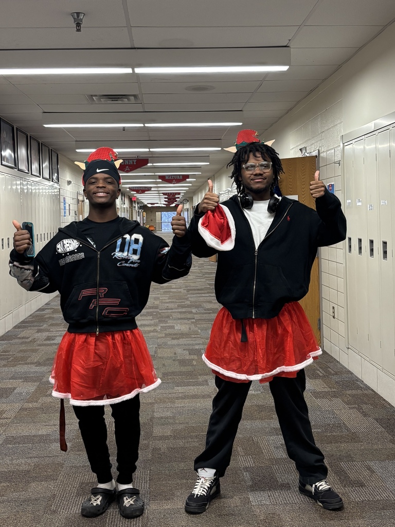 Tino Horton and Rasheen Wilson wearing elf hats and giving two thumbs up