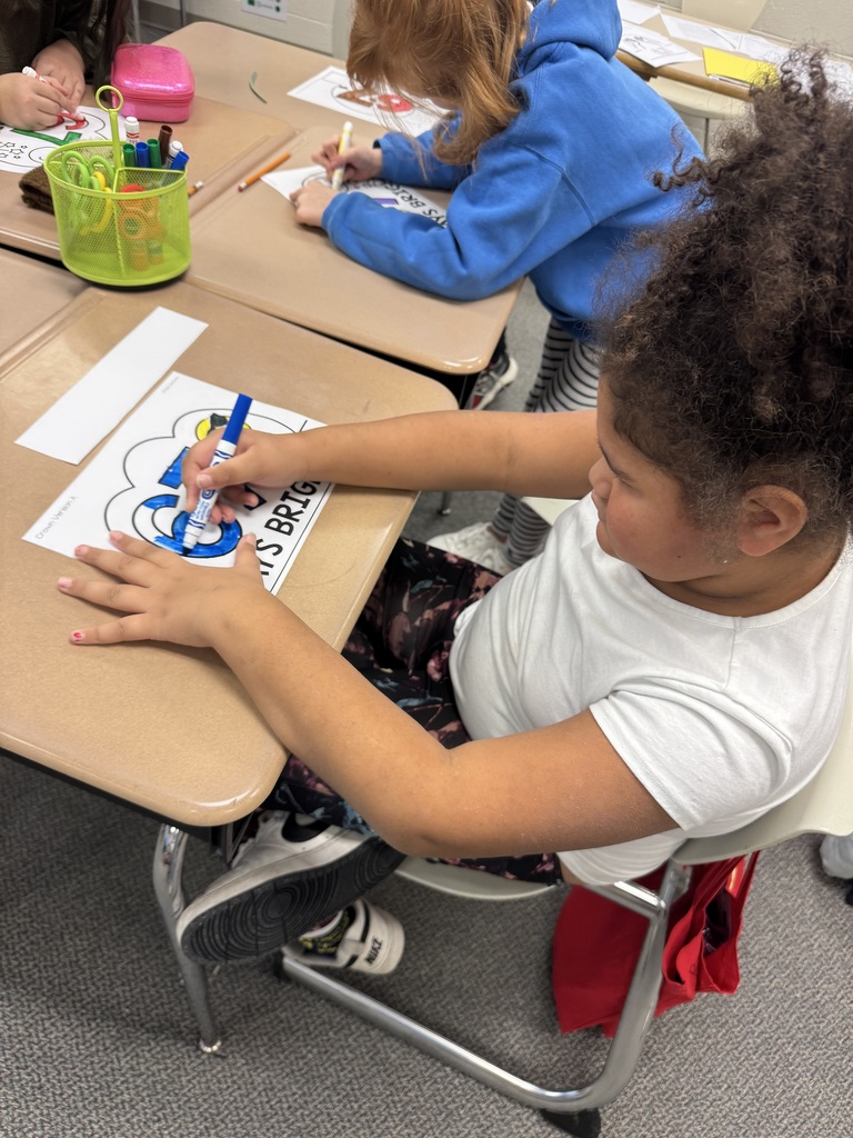 Student coloring a 6-7 coloring sheet