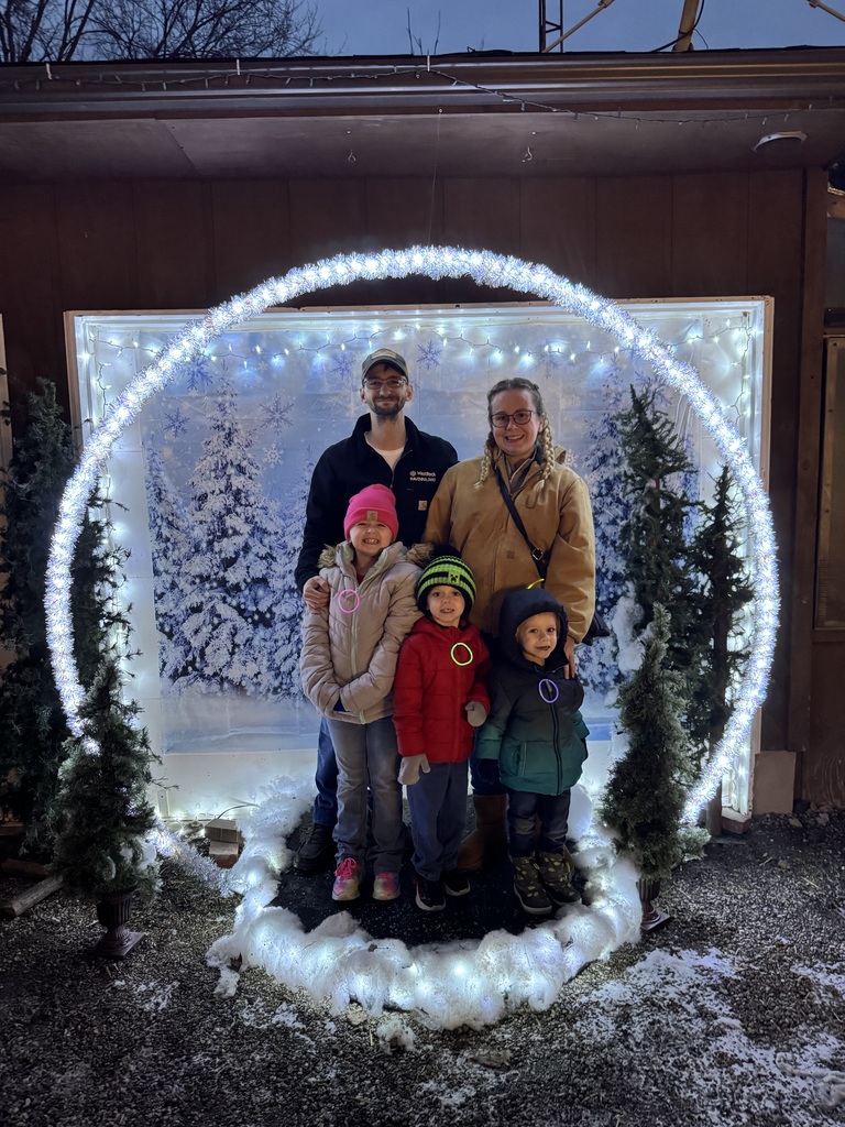 Reed family standing in lights that look like a snow globe