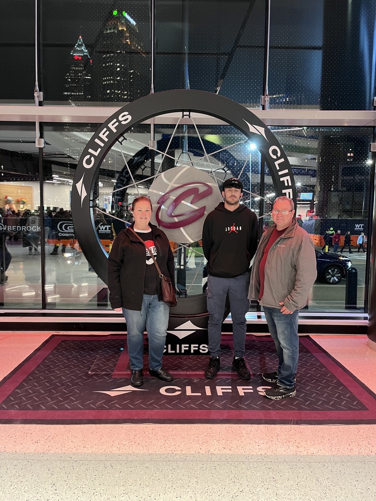 The Dubajs and Marco Standing in front of the cavs logo