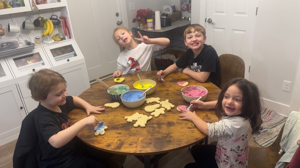 The 4 kiddos putting icing on cookies