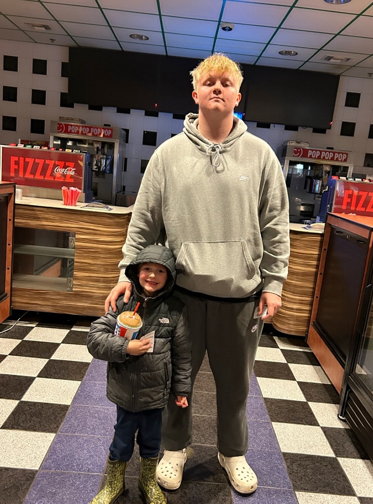 Jameson and Gavin standing in front of the snack counter