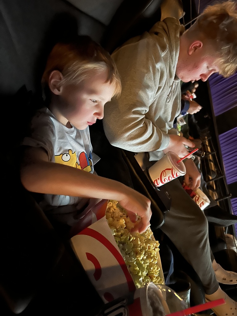 Jameson and Gavin at the movies eating popcorn