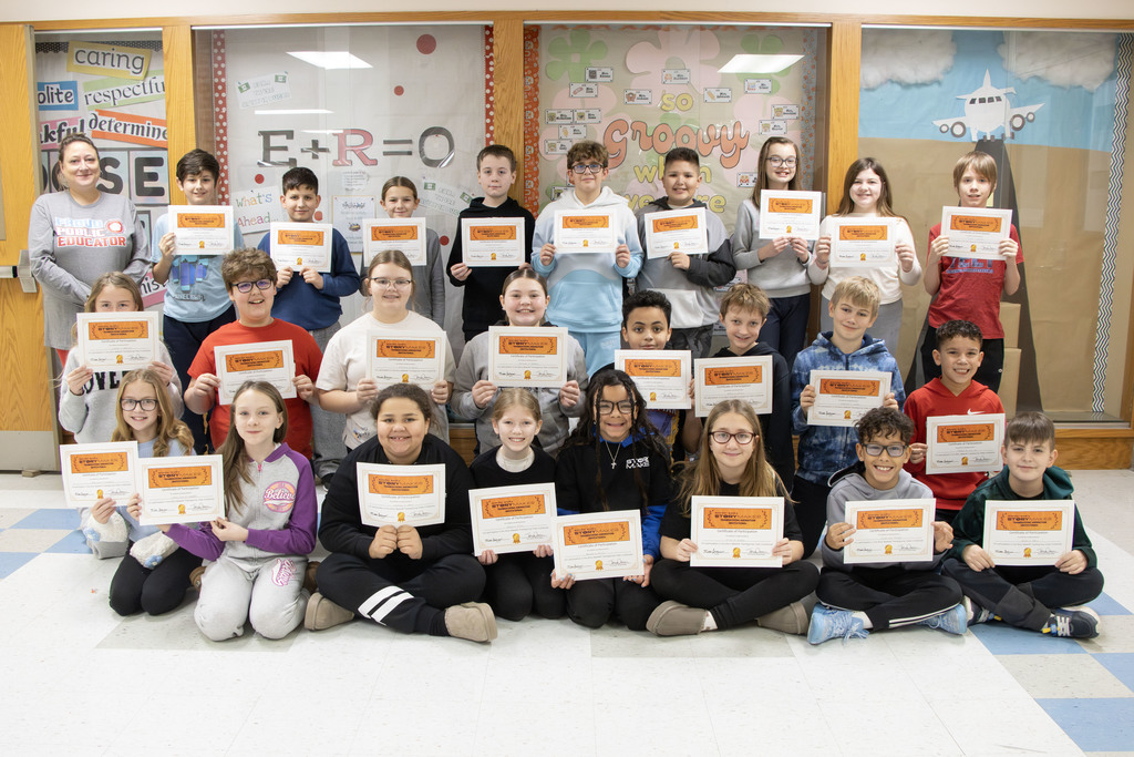 group picture of the class holding their certificates for participating in the compeition